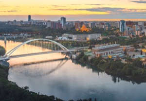 Aerial shot of edmonton at sunset showing the river wrapping around downtown