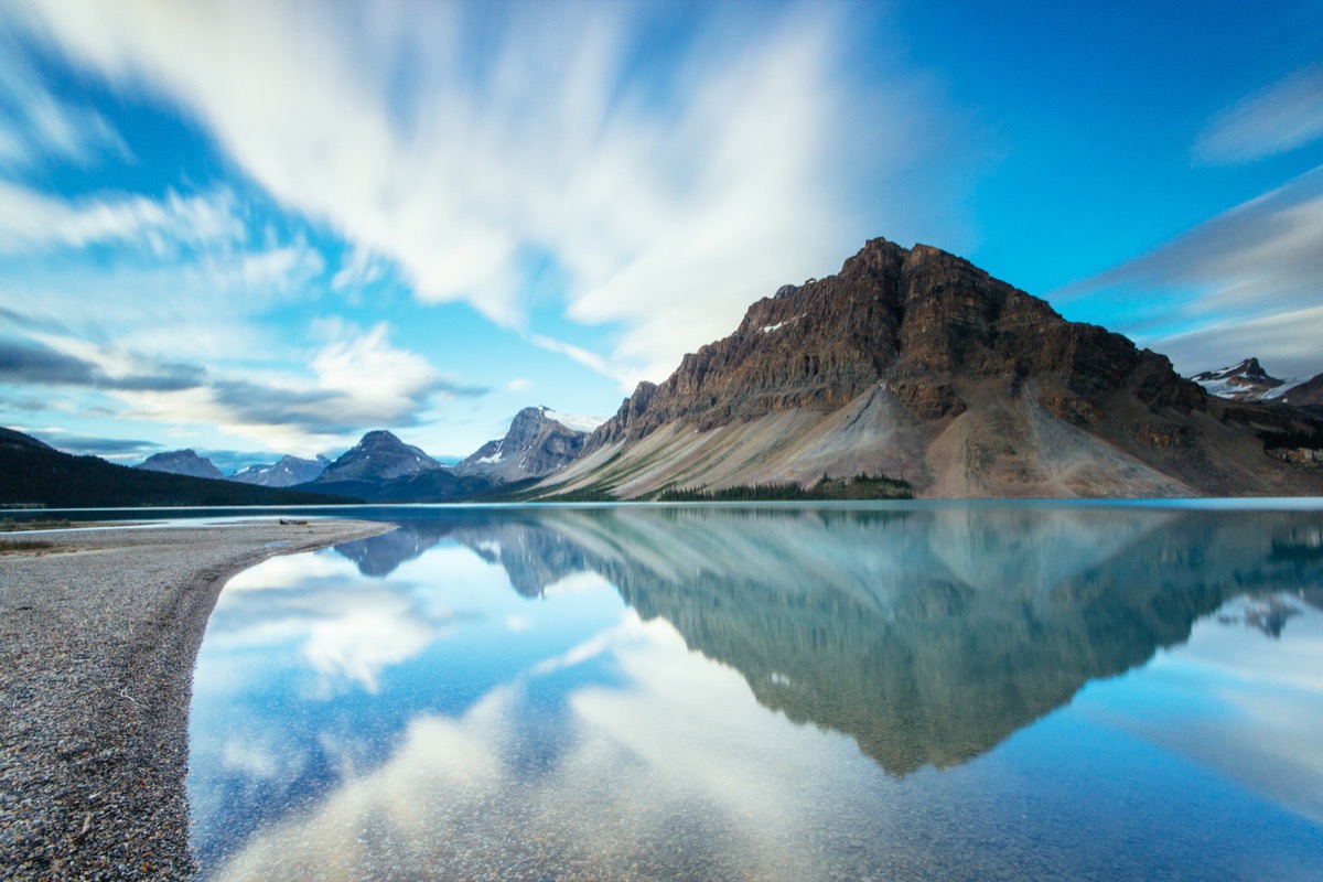 Mountains reflecting in a still lake in the albertan rockies