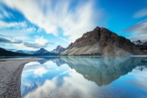 Mountains reflecting in a still lake in the albertan rockies